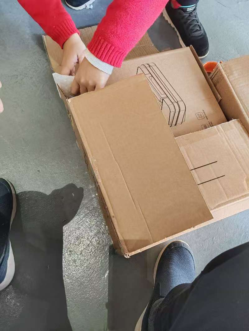 Carefully placing products into new boxes during China sourcing repacking
