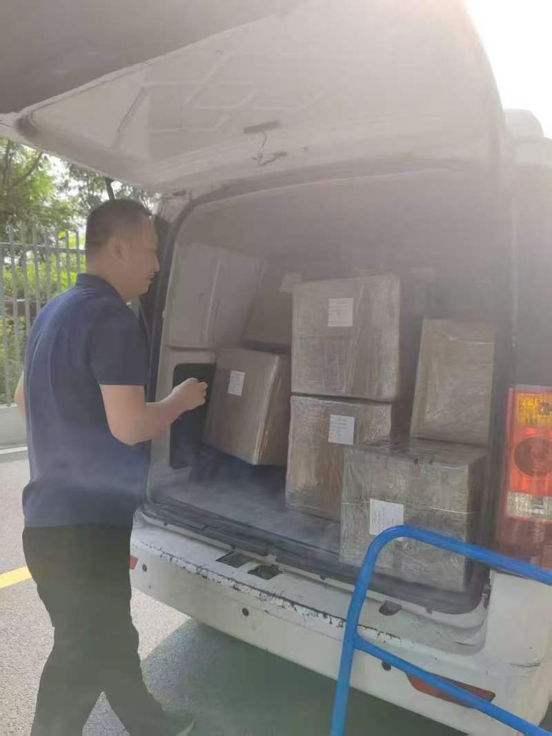 Loading consolidated battery electronics shipments into a forwarder van.