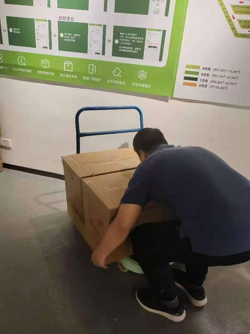 Zhiwei Yan organizing consolidated boxes in the storage area.